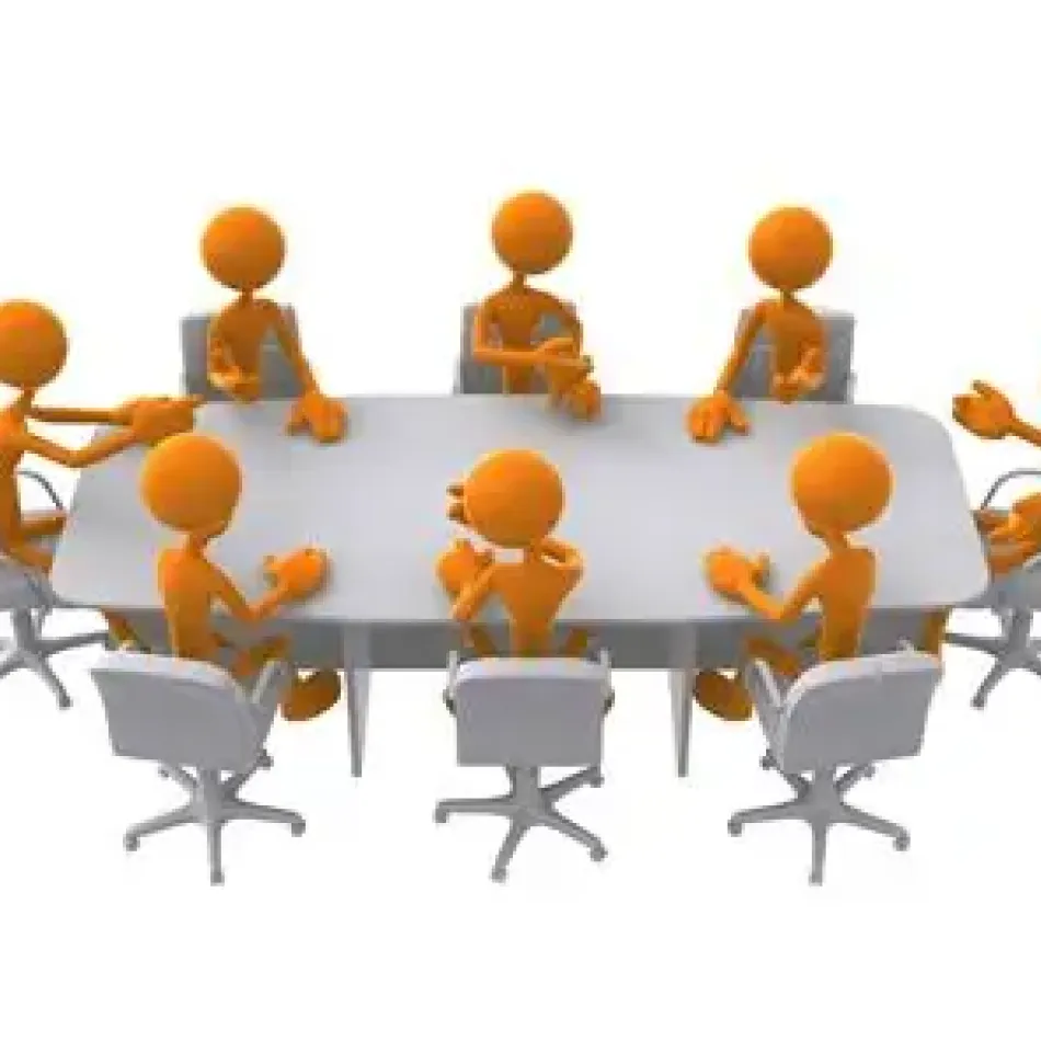 Picture of people sat around a table attending a meeting